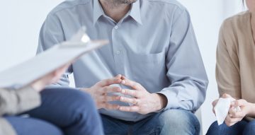 Conflicted husband and wife during divorce mediation with psychologist